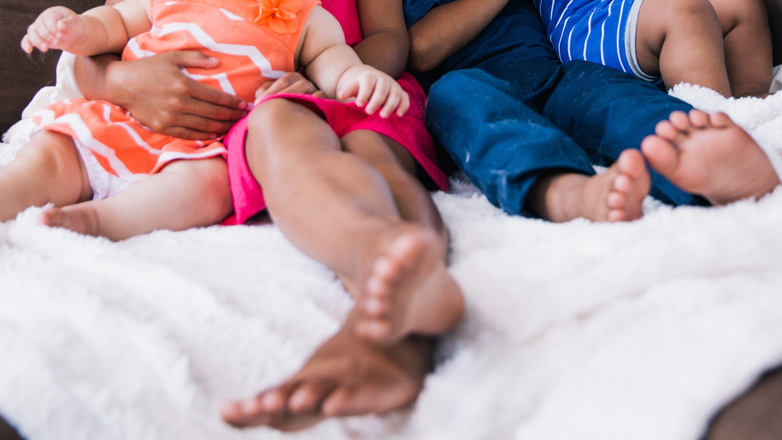 Family Responsibility Office- kids feet on bed with parent