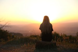 A woman watching the sun rise.