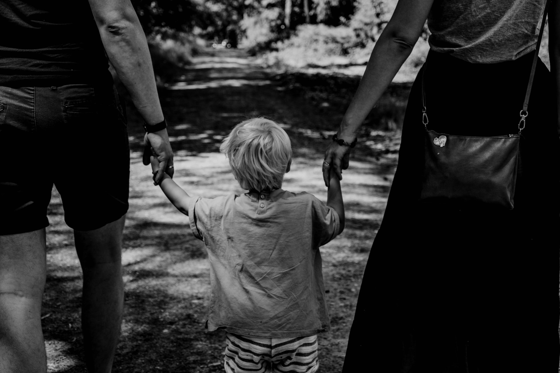 Parents holding hand of child