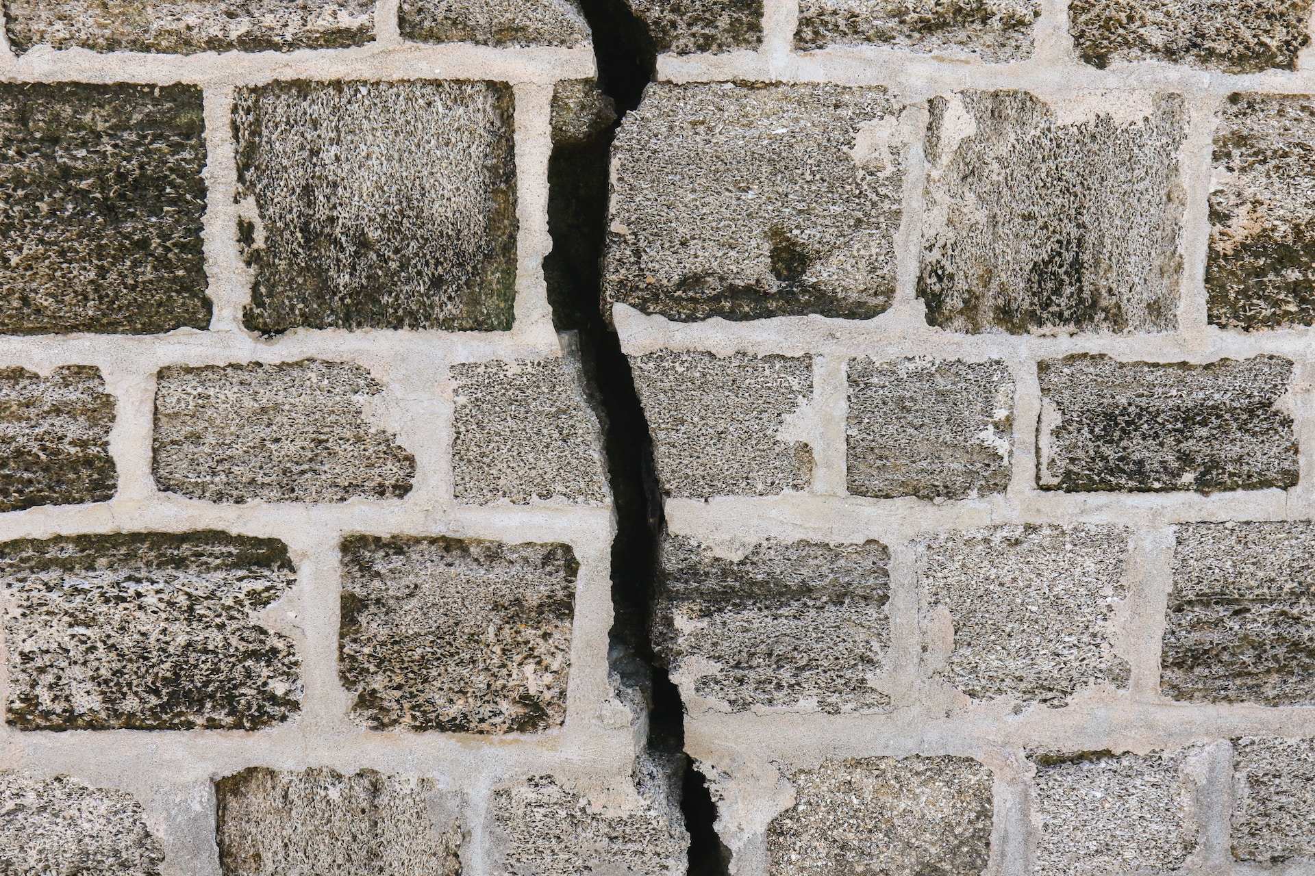 white and gray brick photo with crack in cement