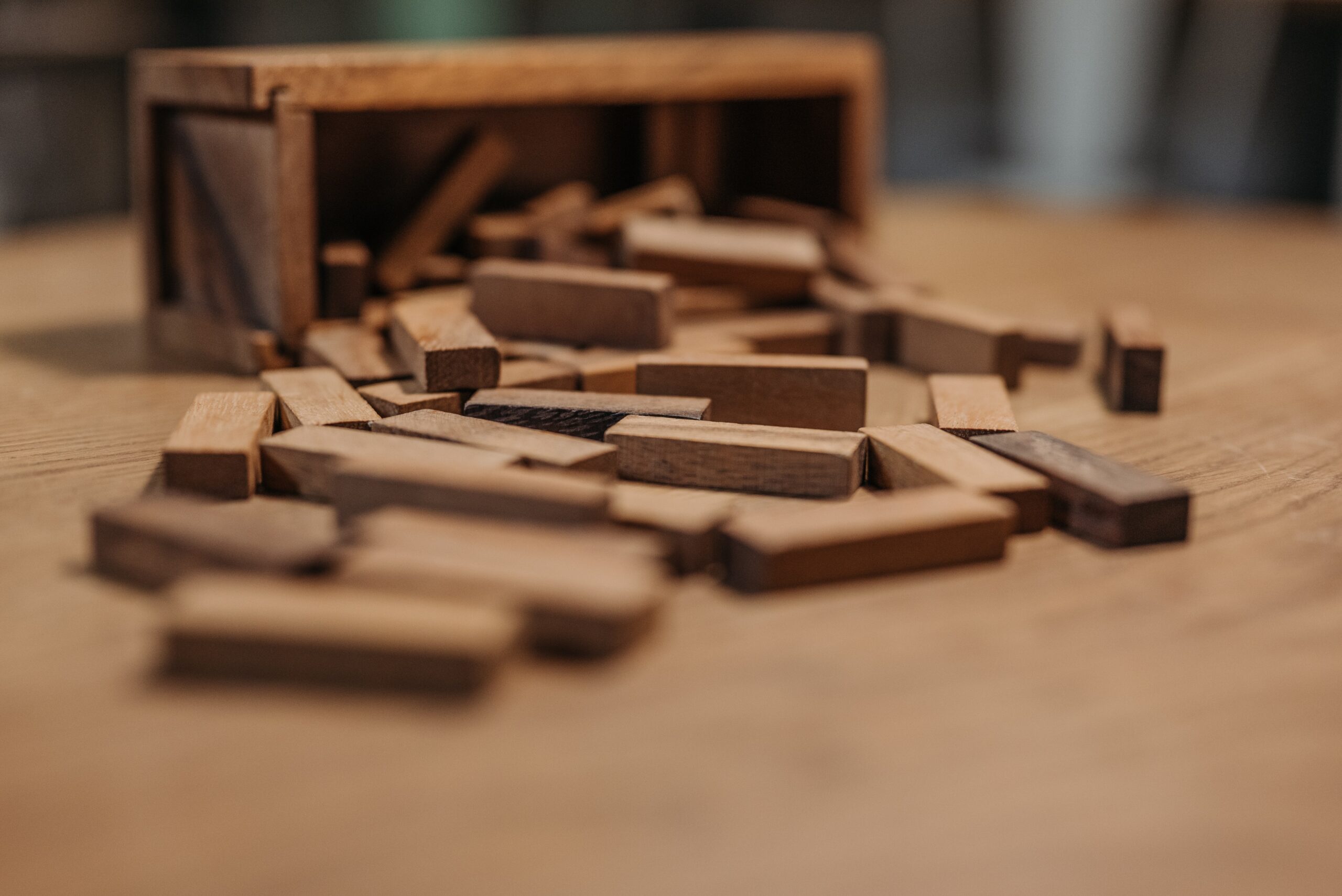 Wooden blocks falling representing parenting orders in the context of family violence