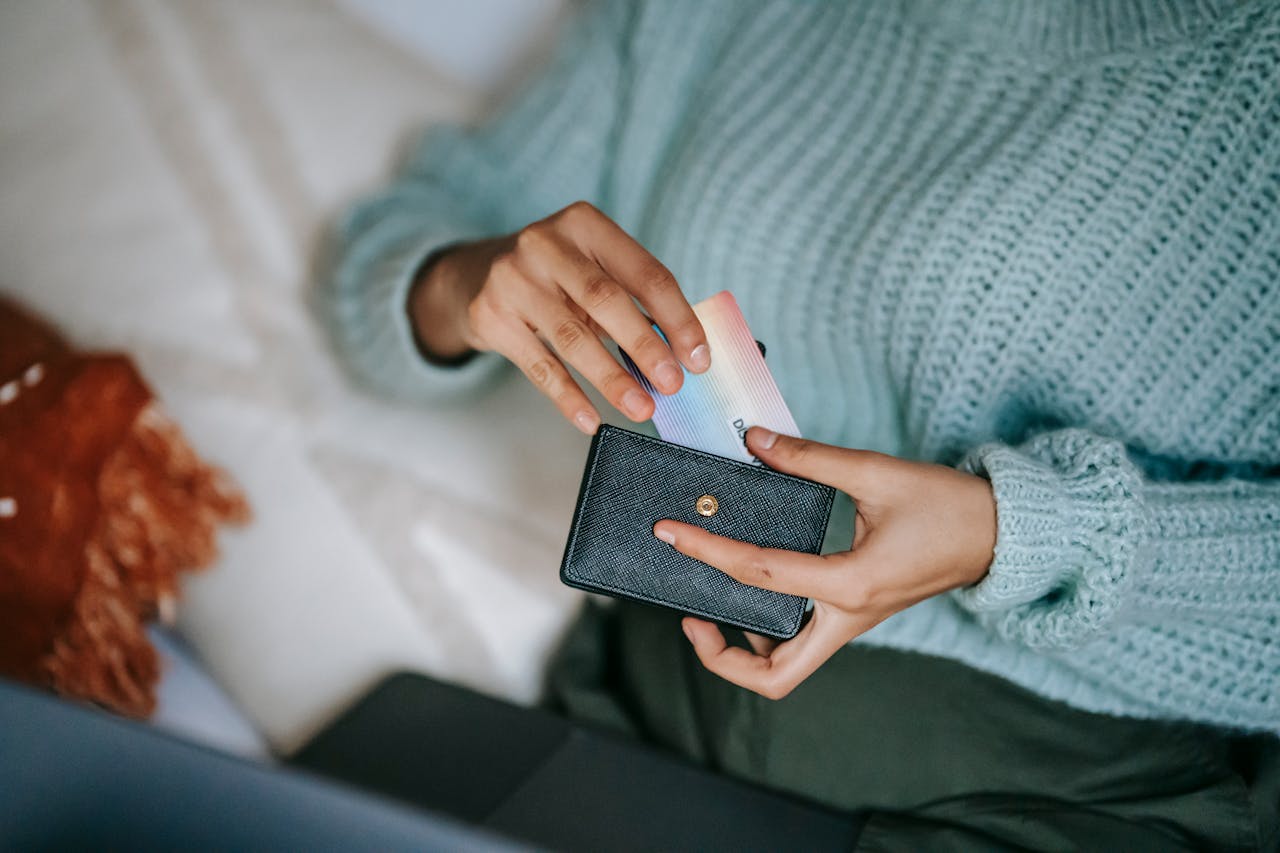 a woman pulling a card out from wallet