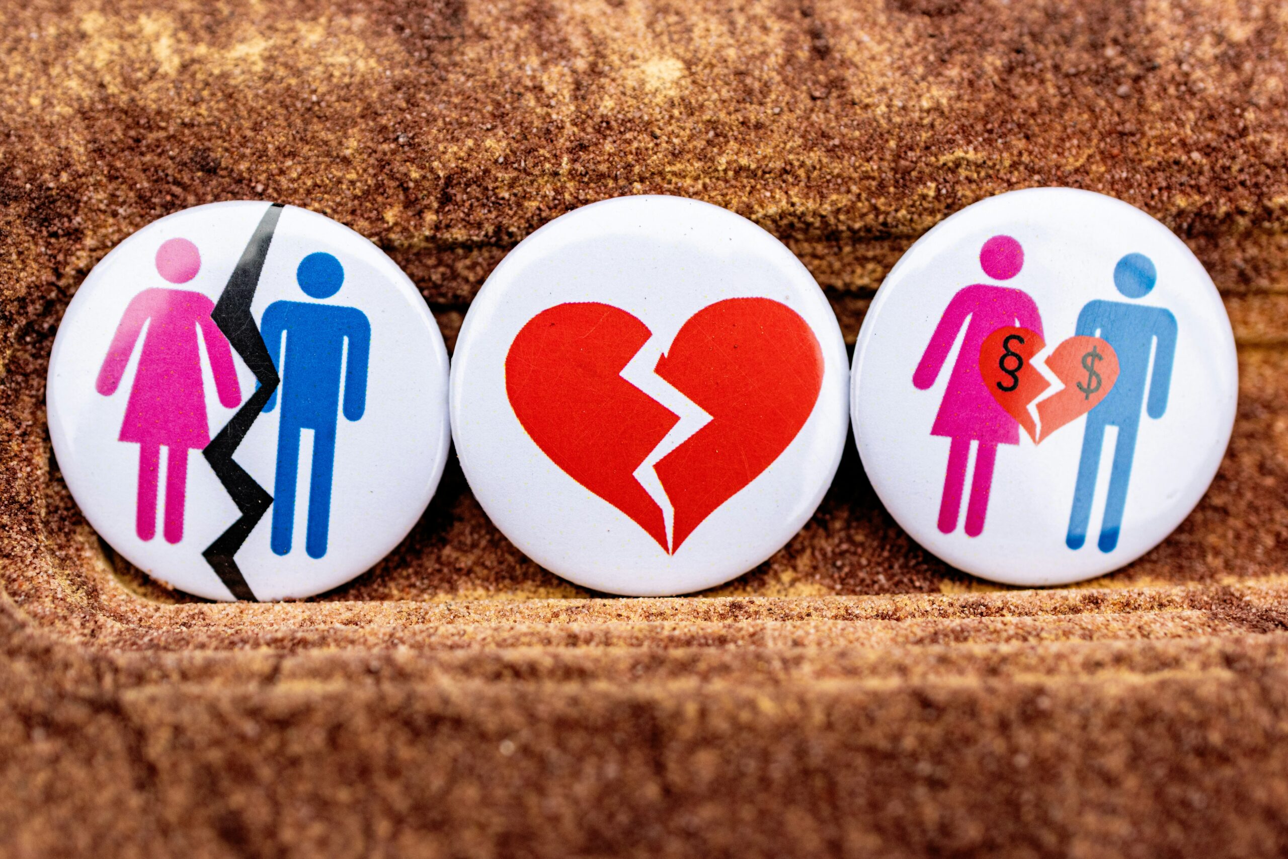 Pins depicting divorce, broken heart and finances representing spousal support variations