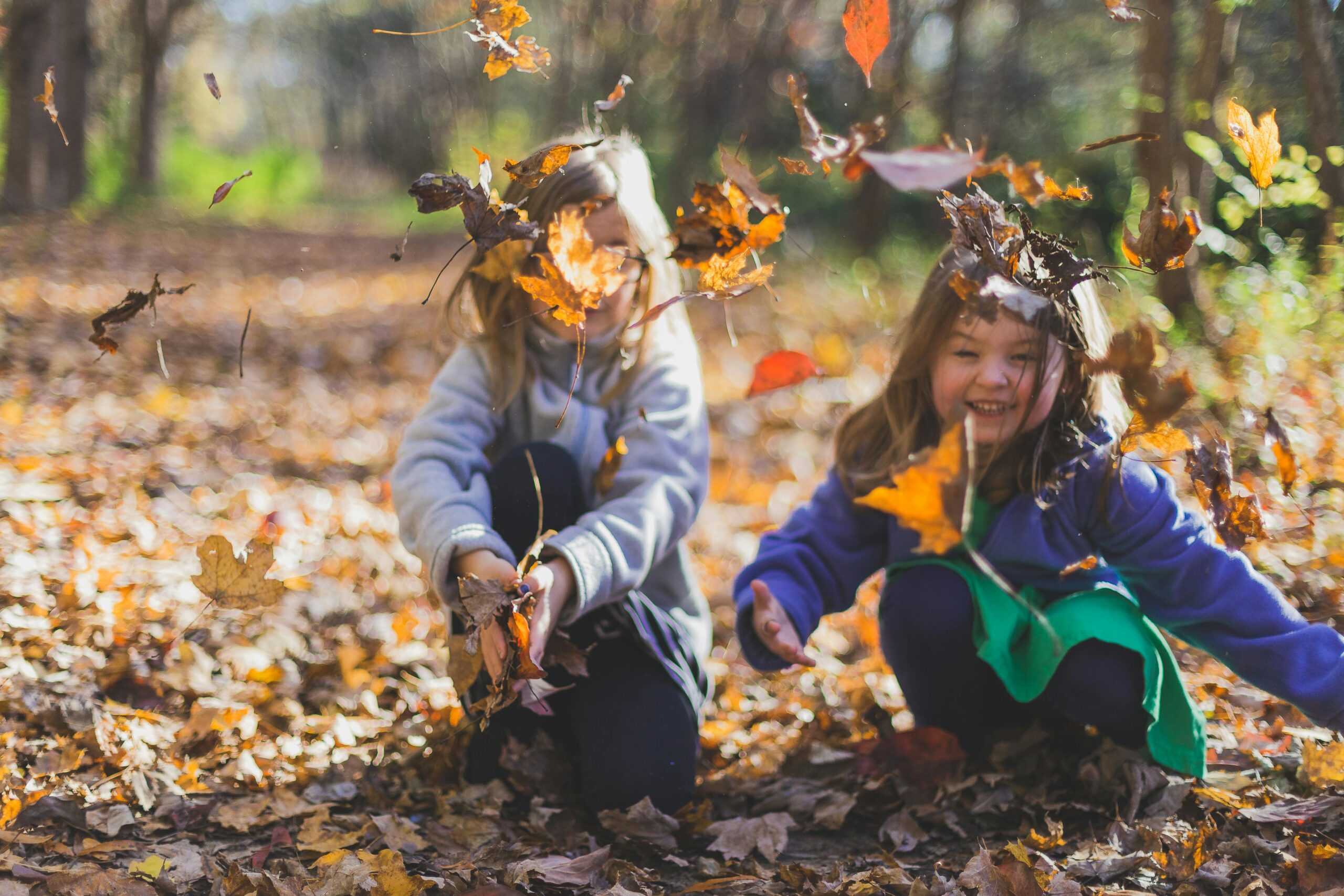 Children playing in leaves representing off-setting debts in child support cases