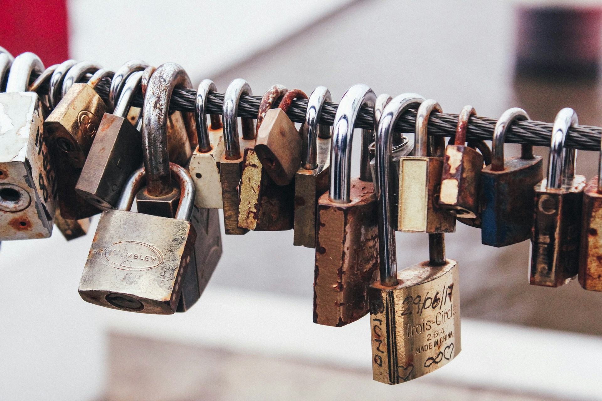 a line of padlocks on a steel fence