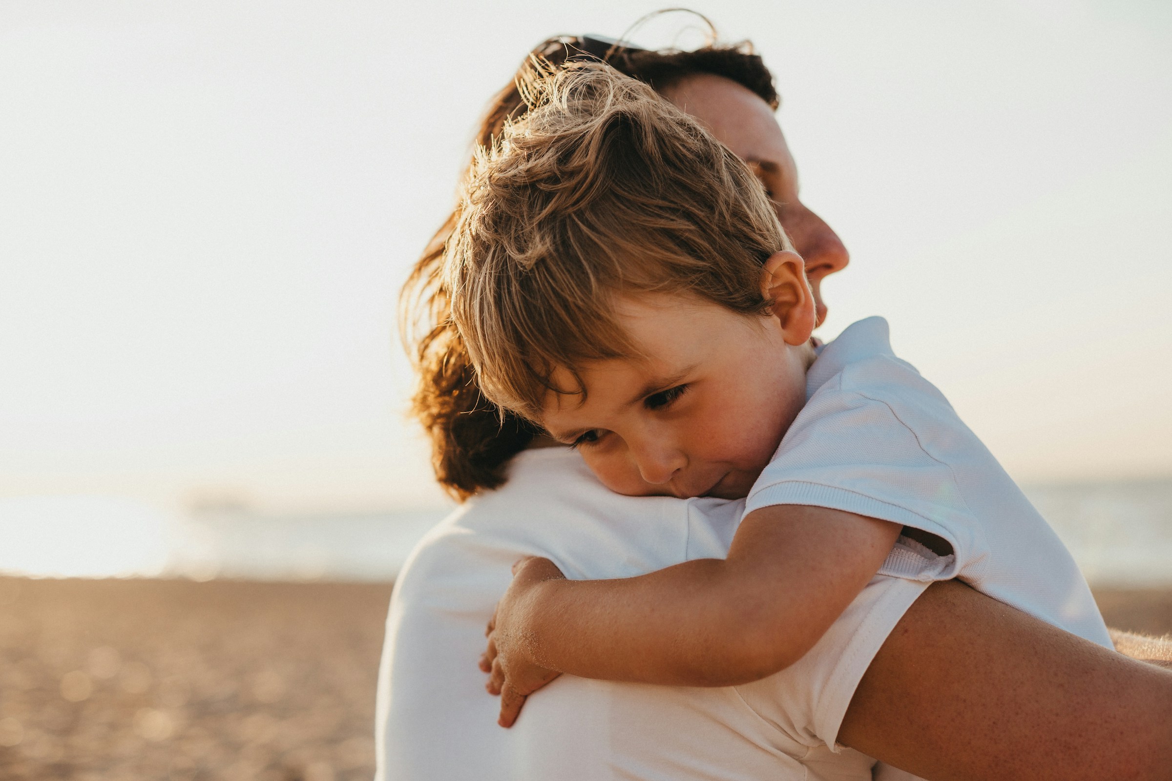 A young boy hugging his mother