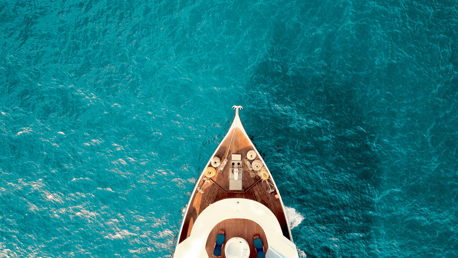 A birds eye view of the bow of a boat in the water, representing high-net worth assets.